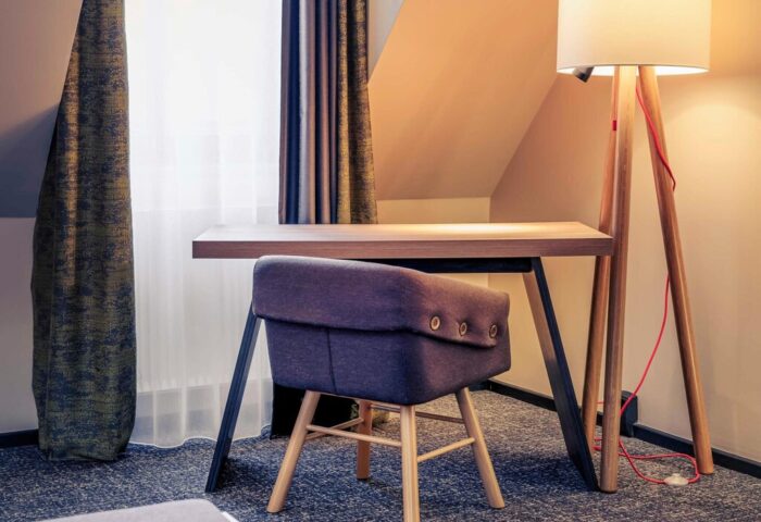Mercure Munich City Center Hotel room. Desk and chair with floor lamp. Gay-friendly hotel in Munich for gay men travel advice.