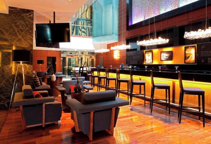Mexico City Marriott Reforma Hotel bar area. Gay-friendly hotel with modern design, bar stools, and lounge seating. Ideal for gay travel.