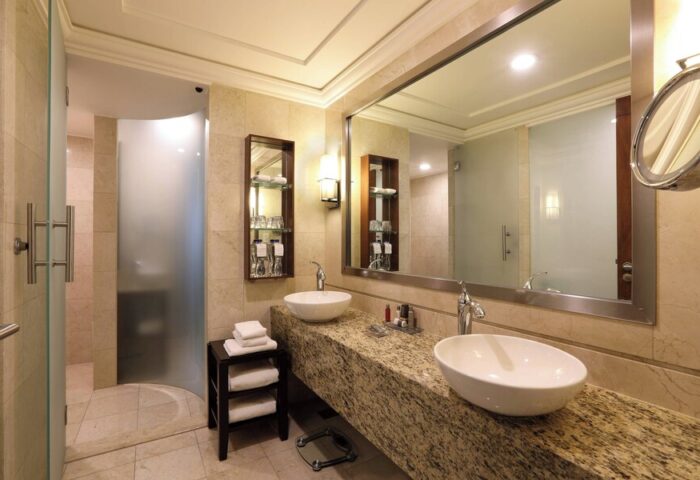 Bathroom at Mexico City Marriott Reforma Hotel. Double sinks, granite countertop, frosted glass shower. Gay-friendly hotel in Mexico City.