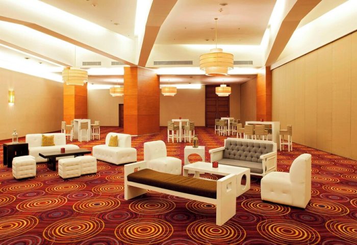 Mexico City Marriott Reforma Hotel's gay-friendly space. Lounge area with seating, tables, and barstools. Stylish design for LGBTQ+ travelers.