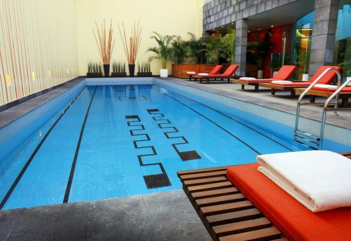 Mexico City Marriott Reforma Hotel pool. Gay-friendly hotel with lounge chairs. Indoor pool with black pattern. Great for gay travel.