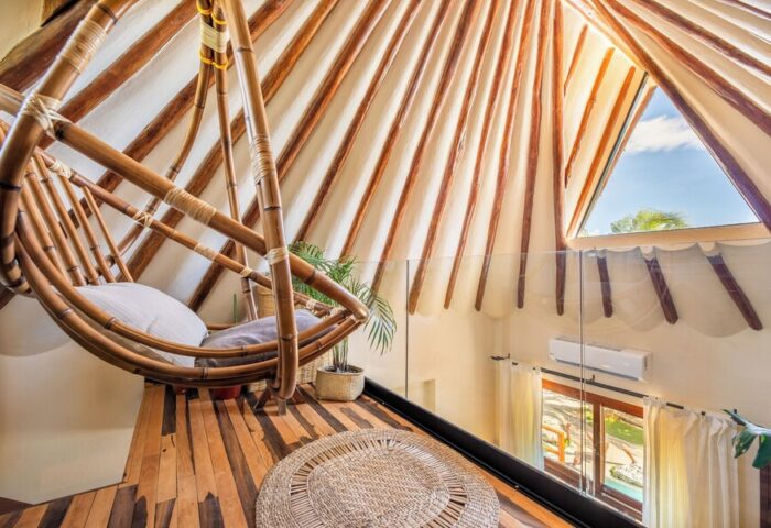 Mezzanine at Colibri Boutique Hotel (Adults Only). Gay-friendly hotel room with hanging chair, wooden floor, and triangular window view.