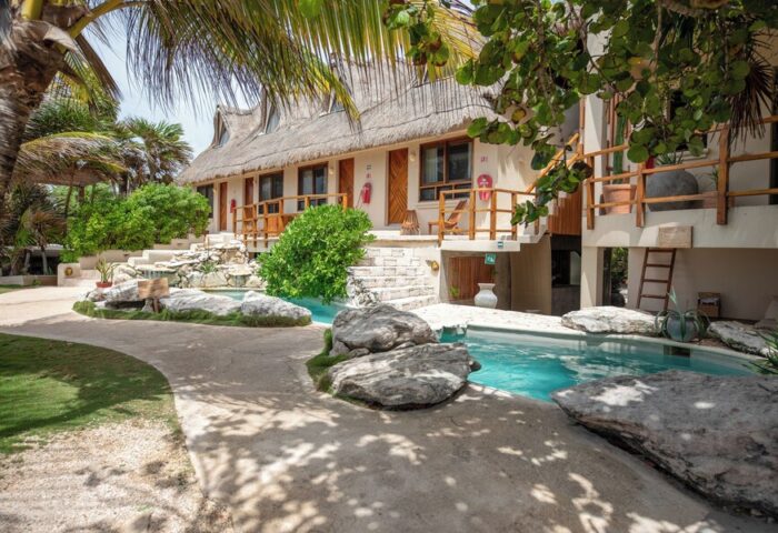 Mezzanine a Colibri Boutique Hotel pool view. Gay-friendly adults-only hotel with thatched roof. Tropical destination for gay travel.