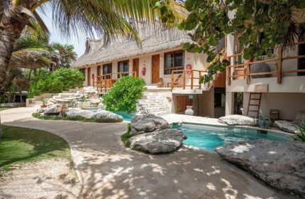 Mezzanine a Colibri Boutique Hotel pool view. Gay-friendly adults-only hotel with thatched roof. Tropical destination for gay travel.