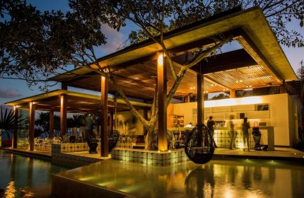 Mi Amor a Colibri Boutique Hotel-Adults Only. Gay-friendly hotel exterior with pool, bar, and lounge area at dusk. Gay travel destination.