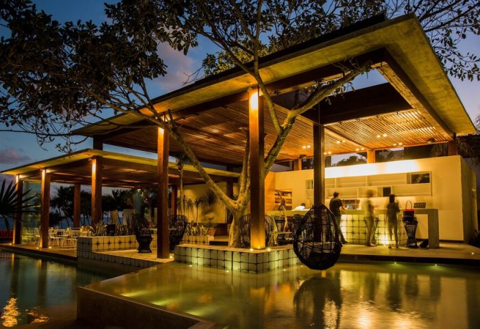 Mi Amor a Colibri Boutique Hotel-Adults Only. Gay-friendly hotel exterior with pool, bar, and lounge area at dusk. Gay travel destination.