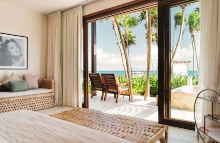 Mi Amor a Colibri Boutique Hotel Adults Only room view. Gay-friendly hotel with ocean view, chairs, and palm trees. A tropical getaway.
