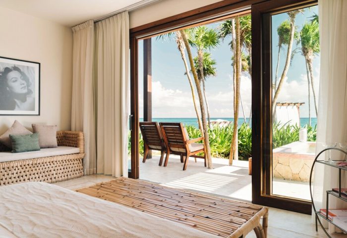Mi Amor a Colibri Boutique Hotel Adults Only room view. Gay-friendly hotel with ocean view, chairs, and palm trees. A tropical getaway.