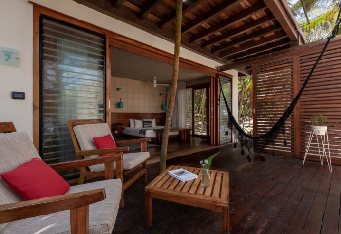 Mi Amor a Colibri Boutique Hotel Adults Only: Gay-friendly hotel room's deck with hammock, chairs, and view to the bedroom. Relaxing gay travel.
