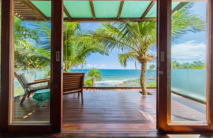 Mi Amor a Colibri Boutique Hotel-Adults Only view. Gay-friendly hotel room with ocean view, palm trees, and wooden deck. Tropical getaway.
