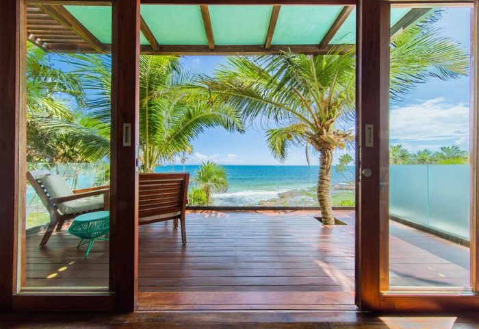 Mi Amor a Colibri Boutique Hotel-Adults Only view. Gay-friendly hotel room with ocean view, palm trees, and wooden deck. Tropical getaway.