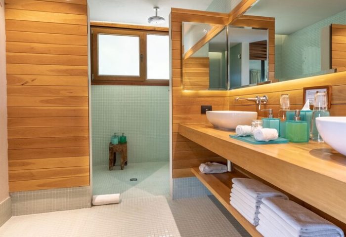 Bathroom at Mi Amor a Colibri Boutique Hotel Adults Only. Gay-friendly hotel with wood counters, dual sinks, & walk-in shower. Modern design.