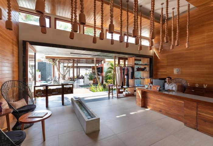 Mi Amor a Colibri Boutique Hotel's lobby. This adults-only, gay-friendly hotel features unique decor, a reception desk, and an open-air design.