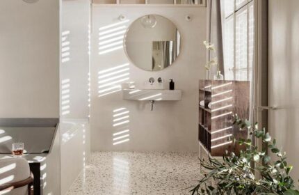 Michelberger Hotel's stylish bathroom. A gay-friendly hotel with a modern design, round mirror, and terrazzo floor. Great choice for gay travel.
