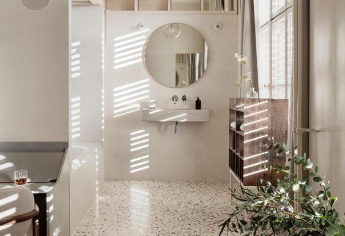 Michelberger Hotel's stylish bathroom. A gay-friendly hotel with a modern design, round mirror, and terrazzo floor. Great choice for gay travel.