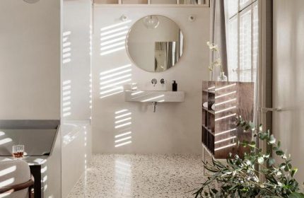 Michelberger Hotel's stylish bathroom. A gay-friendly hotel with a modern design, round mirror, and terrazzo floor. Great choice for gay travel.