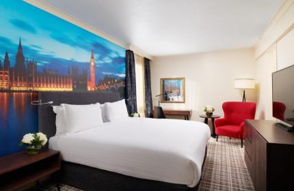 Millennium Gloucester Hotel London bedroom. Gay-friendly hotel with a double bed and a mural of the Houses of Parliament and Big Ben.