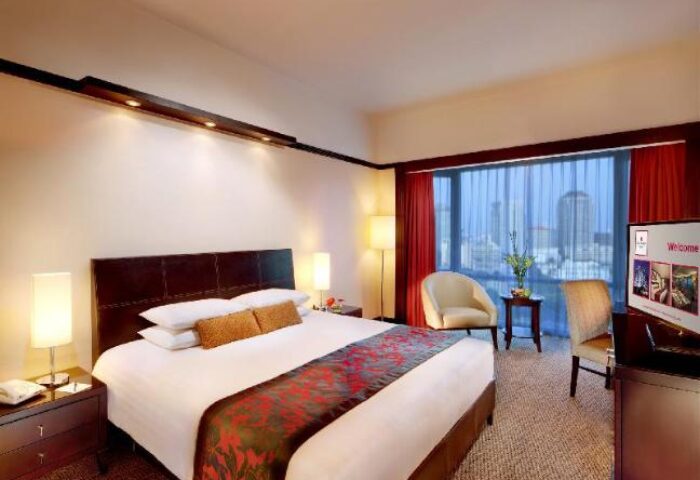 Millennium Hotel Sirih Jakarta room. Gay-friendly hotel bedroom with a large bed, city view, and modern decor. Jakarta hotel for gay travelers.