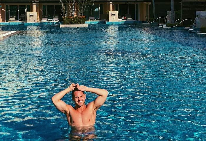 Gay-friendly M Social Hotel Phuket: Man in pool at Millennium Resort Patong. Gay travel in Phuket, Thailand. LGBTQ+ vacation.