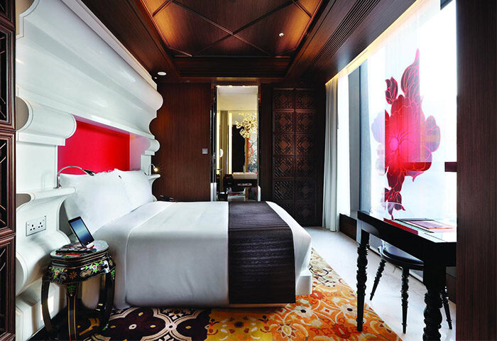 Mira Moon Hotel room, a gay-friendly hotel. Features a bed, desk, and ornate decor. A stylish choice for gay men's travel in Hong Kong.