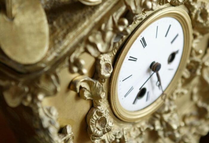 Ornate gold clock detail at Mirador de Dalt Vila, a gay-friendly Relais & Chateaux hotel in Ibiza. Luxury travel for gay men.