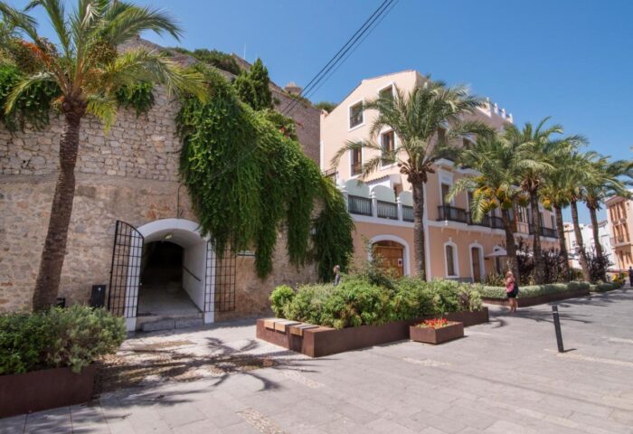 Mirador de Dalt Vila-Relais & Chateaux: Gay-friendly hotel exterior. Palm trees line the street near the entrance to the Ibiza hotel.