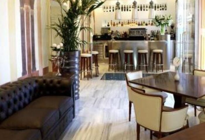 Interior of Mirador de Dalt Vila Relais & Chateaux, a gay-friendly hotel. Bar, seating area, and elegant decor for gay travelers.