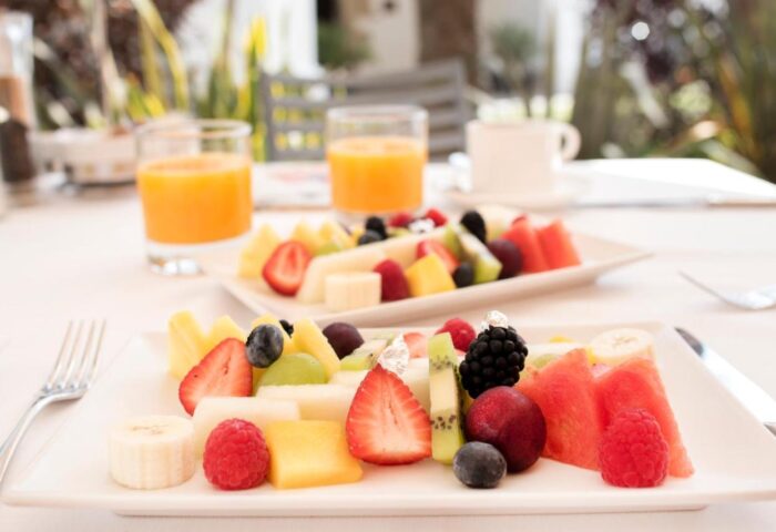 Breakfast at Gay-Friendly Hotel Mirador de Dalt Vila-Relais & Chateaux. Fruit plate and orange juice, a healthy start to the day.