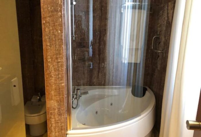 Bathroom interior at Mirador de Dalt Vila-Relais & Chateaux, a gay-friendly hotel. Features a shower, bathtub, and bidet.