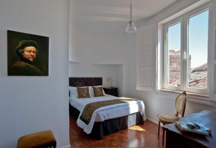 Monte Belvedere Hotel by Shiadu room. Gay-friendly hotel room with bed, chair, desk, and painting. Window view. Great for gay men travel.