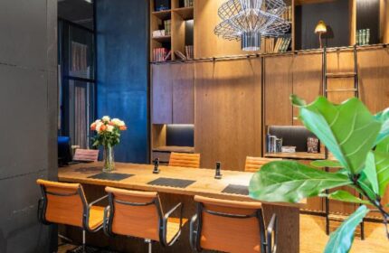 Mosaic House Design Hotel interior. Gay-friendly hotel with modern design, wooden furniture, library, and stylish chairs. Perfect for gay travelers.