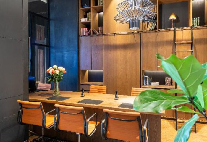 Mosaic House Design Hotel interior. Gay-friendly hotel with modern design, wooden furniture, library, and stylish chairs. Perfect for gay travelers.