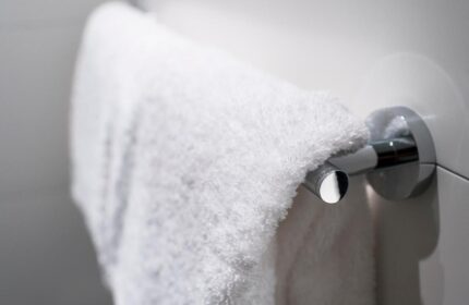 Towel rack at Motel One Koln-Neumarkt. Gay-friendly hotel detail: a fluffy white towel hangs on a modern, chrome towel bar. Cleanliness.