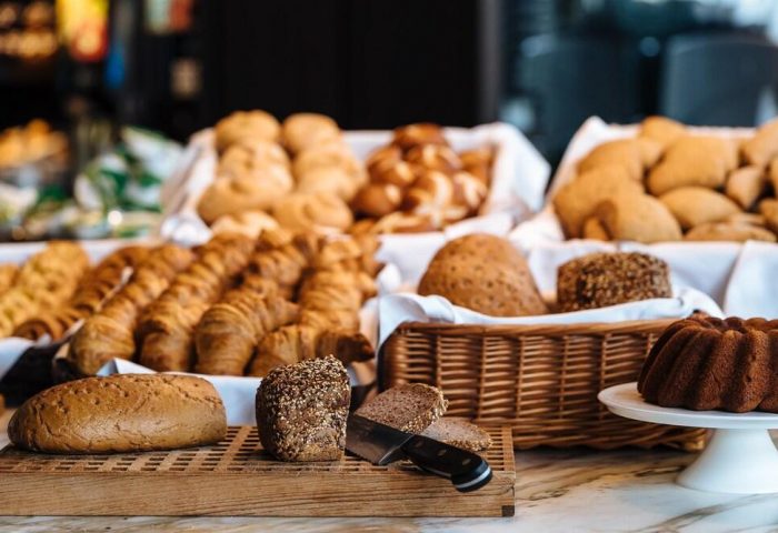 Breakfast buffet at Gay-Friendly Hotel Motel One Manchester-Piccadilly. Bread, croissants, and cake for a delicious start to your day!