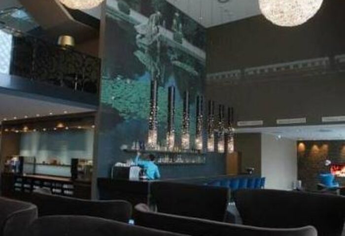 Lounge area at Gay-Friendly Motel One Wien Westbahnhof Hotel. Interior design, bar, and seating. Vienna travel for gay men.