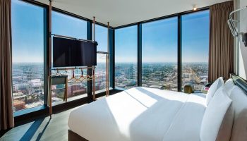 Moxy Downtown Los Angeles hotel room with city view. Gay-friendly hotel with modern design, large windows, and comfortable bed. Perfect for gay travel.