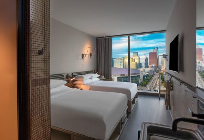 Moxy Downtown Los Angeles hotel room with two beds and city view. Gay-friendly hotel with modern design. Perfect for gay travel.