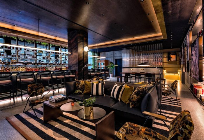 Moxy NYC Chelsea's stylish bar and lounge area. Gay-friendly hotel with a modern design. Perfect for gay men travel and nightlife.