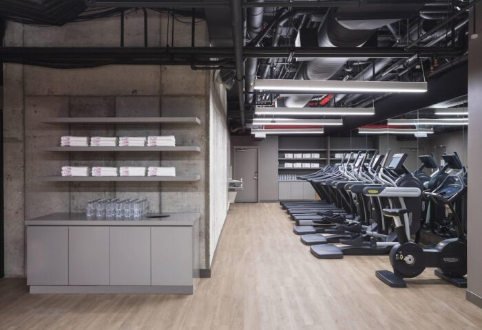 Moxy NYC Chelsea gay-friendly hotel gym. Treadmills, towels, and water are available for guests' use. Modern design.