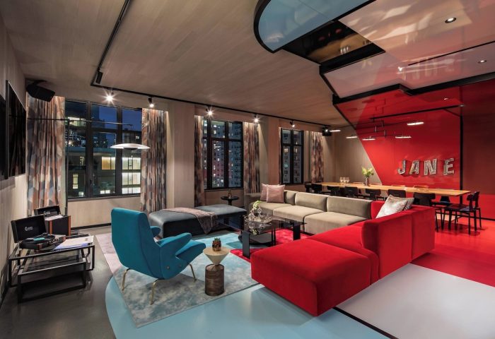 Moxy NYC East Village hotel lounge area. Stylish interior with colorful furniture. Gay-friendly hotel for gay men's travel in NYC.
