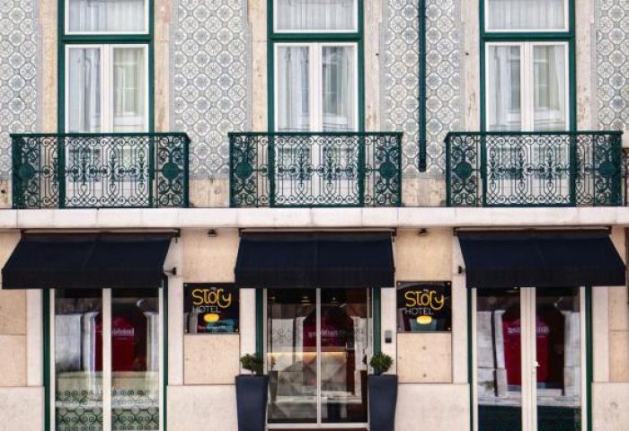 Facade of My Story Hotel Ouro, a gay-friendly hotel in Lisbon. Balconies, awnings, and traditional Portuguese tiles. Travel for gay men.
