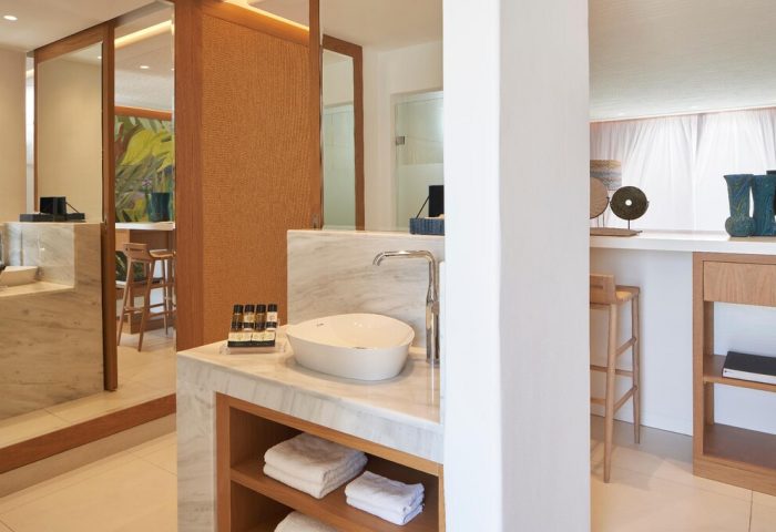 Myconian Kyma Design Hotels gay-friendly bathroom. Marble vanity with sink, towels, and toiletries. Modern, bright, and stylish design.