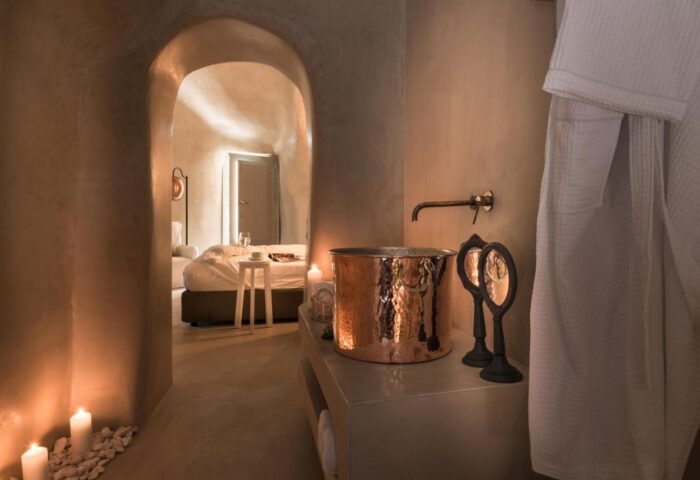 Mythical Blue Luxury Suites gay-friendly hotel room. Copper sink, arched doorway to bedroom, candles. Luxury gay travel.