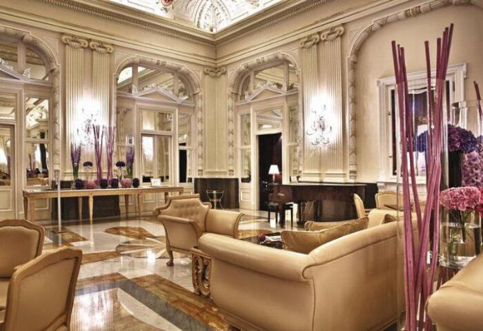 NH Collection Carlo IV's elegant lobby. This gay-friendly, pet-friendly hotel features stylish decor, ornate mirrors, and luxury seating.