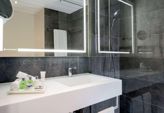 Bathroom at NH Collection Frankfurt City, a gay-friendly hotel. Features modern design, sleek fixtures, and upscale amenities. Ideal for gay travelers.