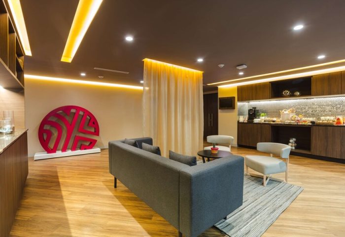 Lounge area at the gay-friendly NH Collection Mexico City Reforma hotel. Modern decor, seating, and buffet. Ideal for gay travelers.