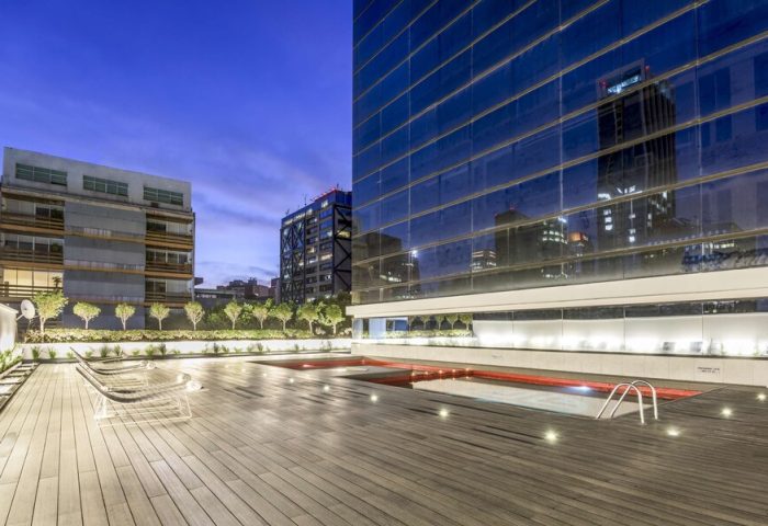 Rooftop pool at the gay-friendly NH Collection Mexico City Reforma hotel. Modern design, wooden deck, city views. Ideal for gay travel.