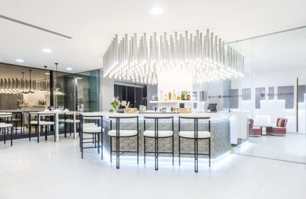 Bar area at the gay-friendly NH Collection Mexico City Reforma hotel. Modern design with stools, tables, and lighting.