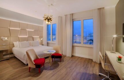 NH Collection Palazzo Cinquecento gay-friendly hotel room. Modern design, large windows, desk, and bed. A great choice for gay men travelers.