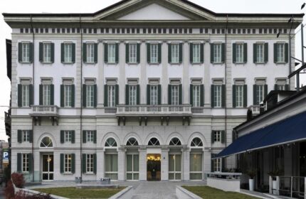 NH Milano Palazzo Moscova facade. Gay-friendly hotel in Milan, Italy. Elegant architecture with green shutters. A top choice for gay travelers.